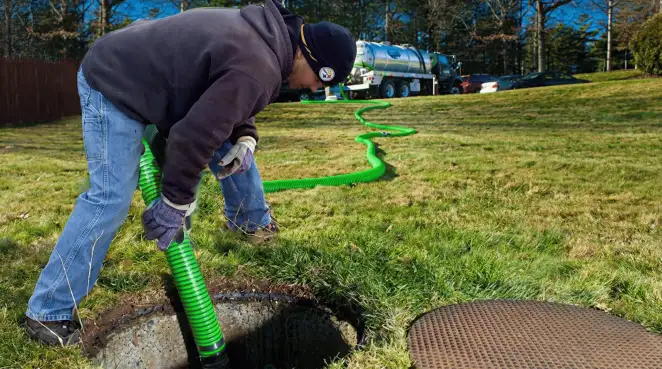 Service technician performing residential septic pumping and drainage maintenance in Pittsburgh, PA